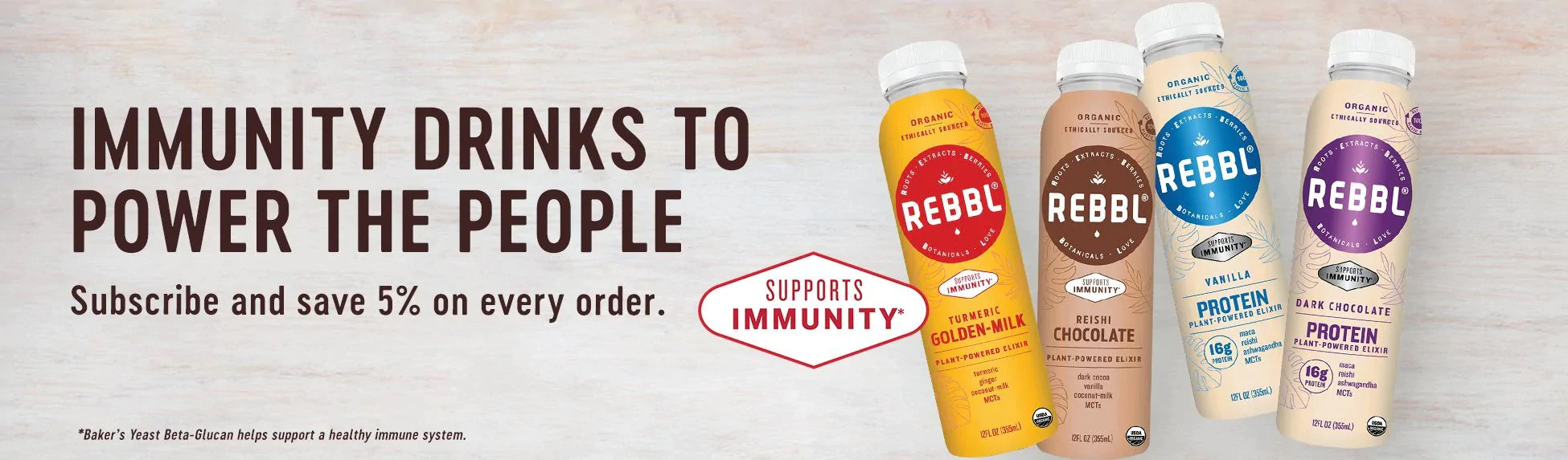 REBBL Plant Protein beverages on a table top surrounded with herbal ingredients